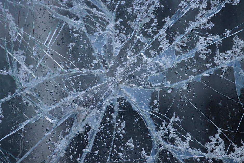Severely cracked car windshield requiring full replacement